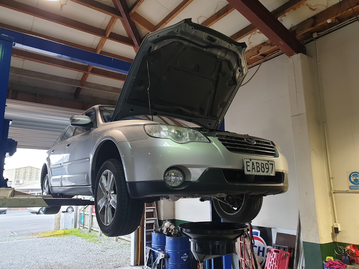 A car raised on the hoist with the bonnet up at Teviot Street Autos